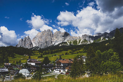 Panoramic view of trees and houses against sky