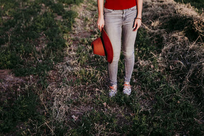 Low section of woman standing on field