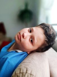 Close-up portrait of cute boy at home