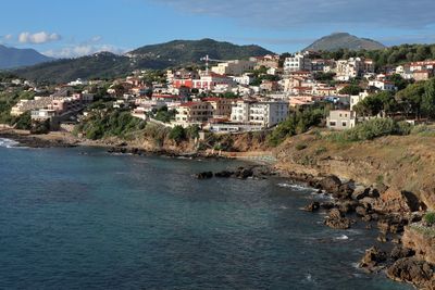 Townscape by sea against sky