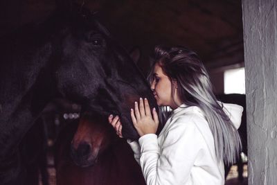 Midsection of young woman in stable