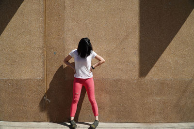 Woman standing against wall