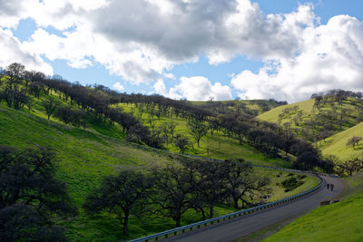 Panoramic shot of road amidst landscape against sky