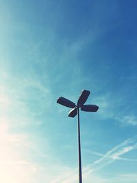 Low angle view of floodlight against blue sky