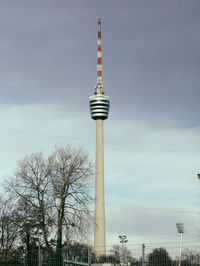 Low angle view of stuttgart tv tower against grey, cloudy sky