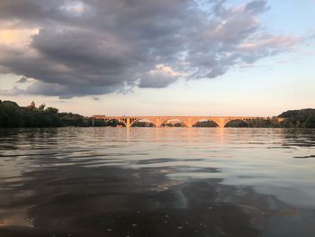 View of bridge over river against cloudy sky
