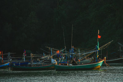 Sailboats moored in sea