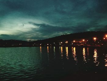 Scenic view of lake against sky at night