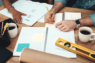 Midsection of businessman working on table