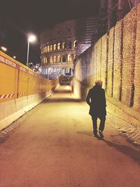 People walking in illuminated city at night
