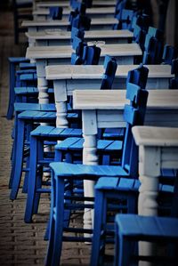 Empty chairs and tables in row