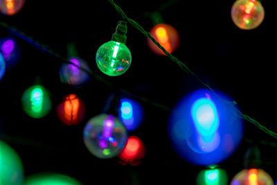 Close-up of illuminated christmas lights at night