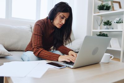 Young woman using laptop at table