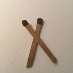 High angle view of cigarette on table against white background