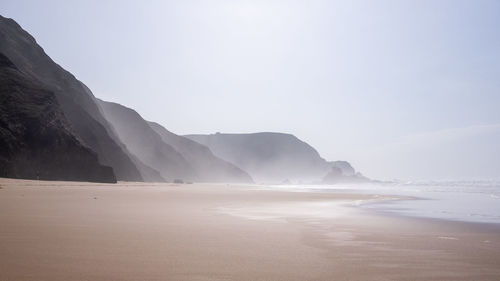 Scenic view of beach against clear sky