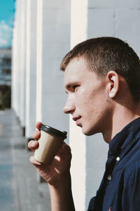 Portrait of teenage boy drinking coffee