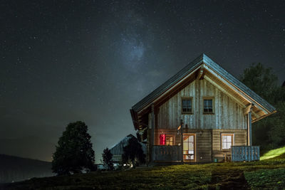 Scenic view of grassy field against sky at night