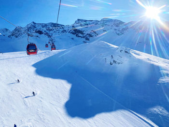 View of people skiing on snow covered mountain