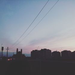 Low angle view of buildings against sky at sunset