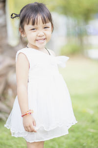 Portrait of girl standing on field