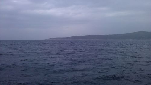 Scenic view of sea against cloudy sky