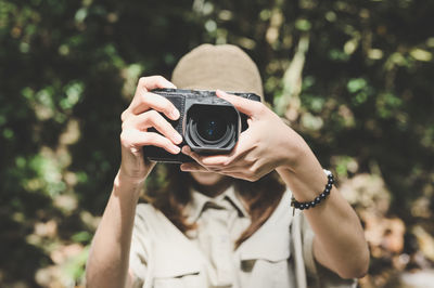 Series photo of young woman photographer with her camera shooting photo outdoor