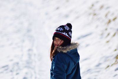 Rear view portrait of girl wearing blue warm clothing during winter