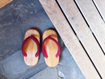 High angle view of wooden flip-flops on floor