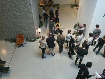 Group of people standing on tiled floor