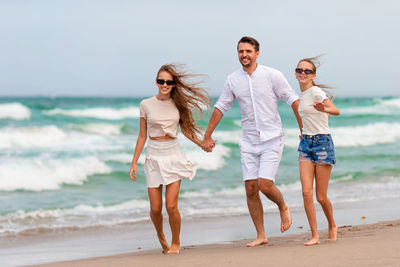 Friends standing at beach