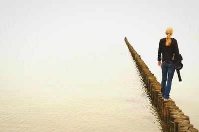 Full length of woman standing by railing