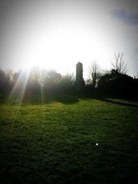 Scenic view of grassy field against sky