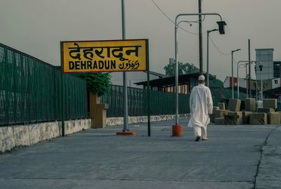 Rear view of man walking on street