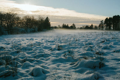 Scenic view of frozen lake against sky during winter