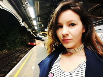 Portrait of beautiful woman at railroad station platform