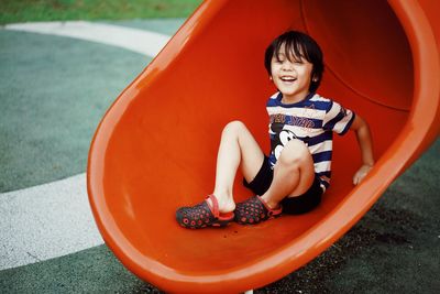 Happy boy sitting in a container