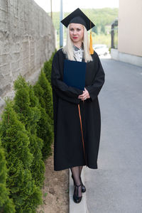 Low section of woman standing on street