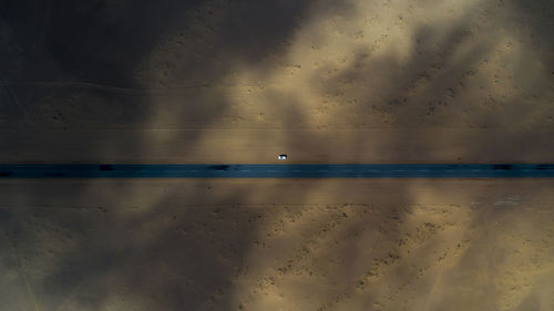 View of bird flying over sea during sunset