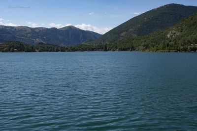 Scenic view of lake and mountains against sky