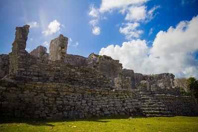 Ruins of temple against cloudy sky