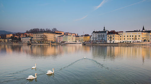 View of river and buildings against sky