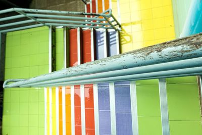 Close-up of multi colored metal railing against building