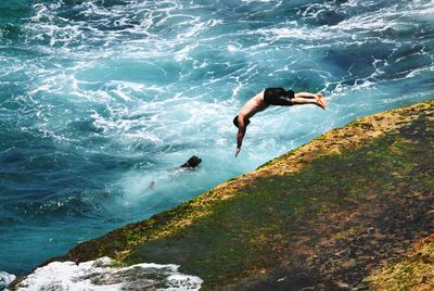 Woman jumping in water