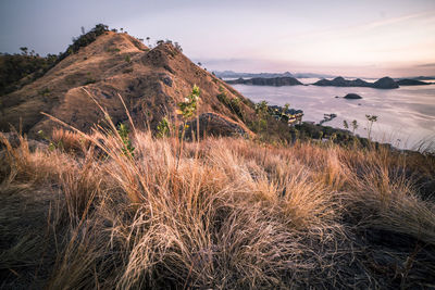 Scenic view of land against sky during sunset, komodo, indonesia 