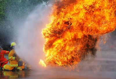 Firefighters spraying water on fire