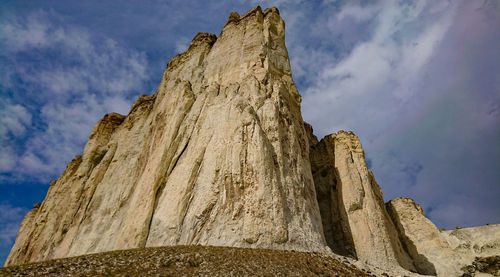 Low angle view of rock formations against sky