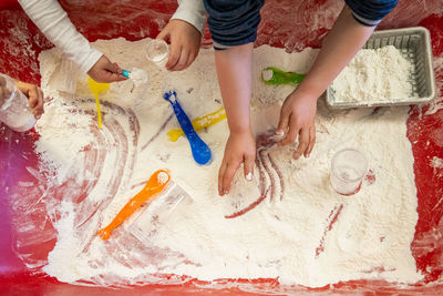 High angle view of people playing with flour