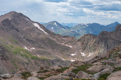 Landscape of bare mountain peaks with a bit of snow on mount evans in colorado