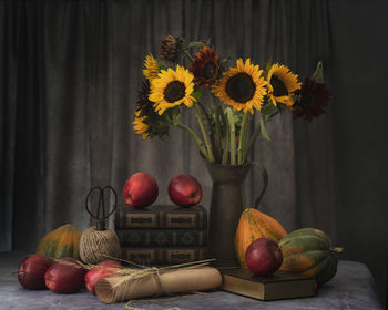 Various flowers in vase on table