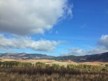 Scenic view of mountains against cloudy sky